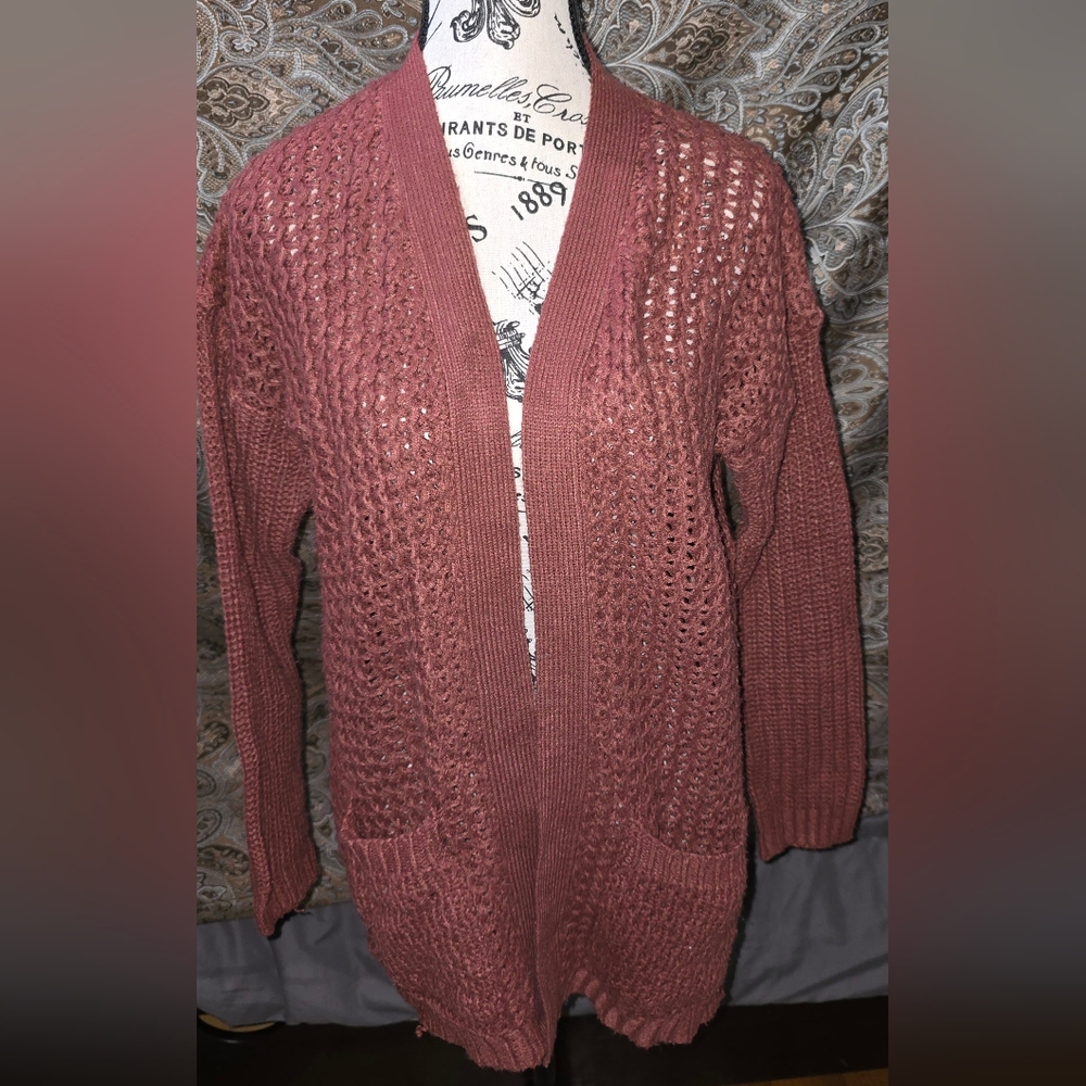 Womens cableknit cardigan sweater.